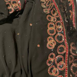 Elegant Black Saree with Red and Gold Detailing